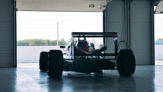 Racing car in a garage unit with nobody inside