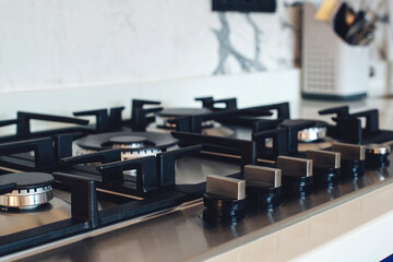 Kitchen gas stove, close up. New gas stove appliance and countertop surface at modern kitchen.