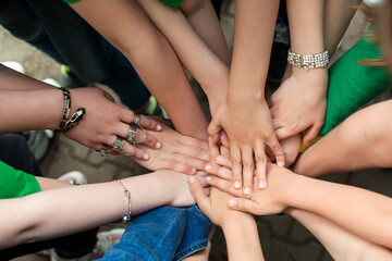 Friends putting their hands on top of each other. Sign of trustful friendship.