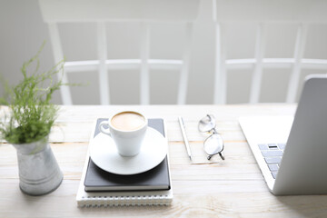 Coffee and notebooks and glasses and laptop