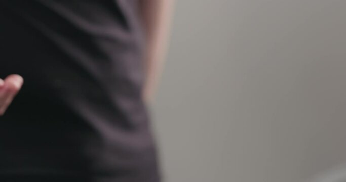 Slow motion man hand show big ripe blueberries on neutral background