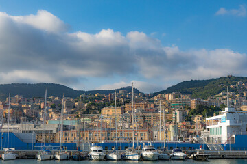 Fototapeta na wymiar View of the port of Genoa full of yachts, boats - in the background high-rise buildings