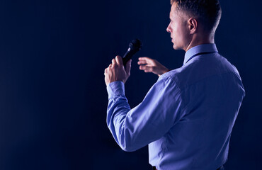 Businessman speech concept, talking with microphone in conference hall