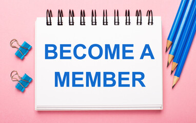On a light pink background, light blue pencils, paper clips and a white notebook with the text BECOME A MEMBER