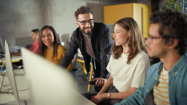Lecturer Helps Scholar with Project, Advising on Their Work. Teacher Giving High Five to Diverse Multiethnic Group of Female and Male Students in College Room, Teaching Software Engineering.