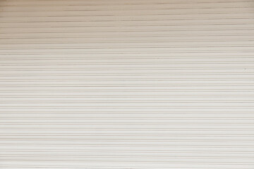 Obraz premium White metal curtain mockup - business closed with white grunge metal roller shutter door