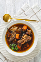 beef broth of beef meat on bones with veggies
