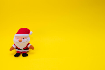 Stuffed funny Santa Claus on yellow background