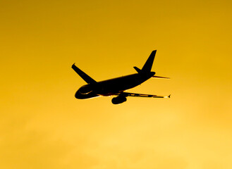 Silhouette of an airplane at sunset.