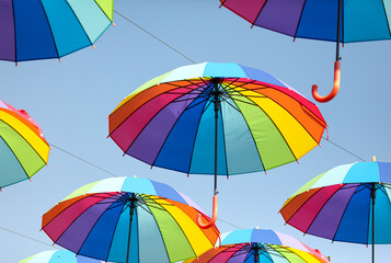 Umbrellas in the color of the rainbow against the  sky.