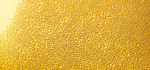 Drops of water on a glass window at dawn as an abstract background.