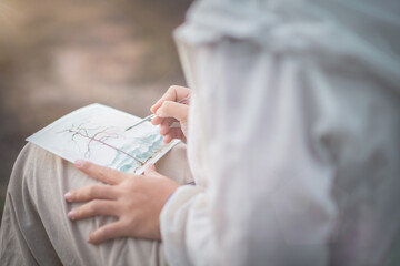 girl sitting painting on a sunny day