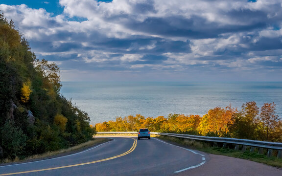 Cabot Trail in Autumn Colors - Car brakes as it descends down the mountain along Cabot Trail, Cape Breton, Nova Scotia on a beautiful day in autumn.
