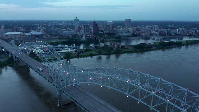 Aerial: Memphis Hernando De Soto Bridge and downtown Memphis at night, Tennessee. USA