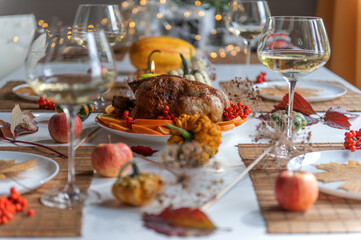 Thanksgiving,Christmas or Halloween celebration traditional dinner  table setting food concept on the background of bokeh lights.