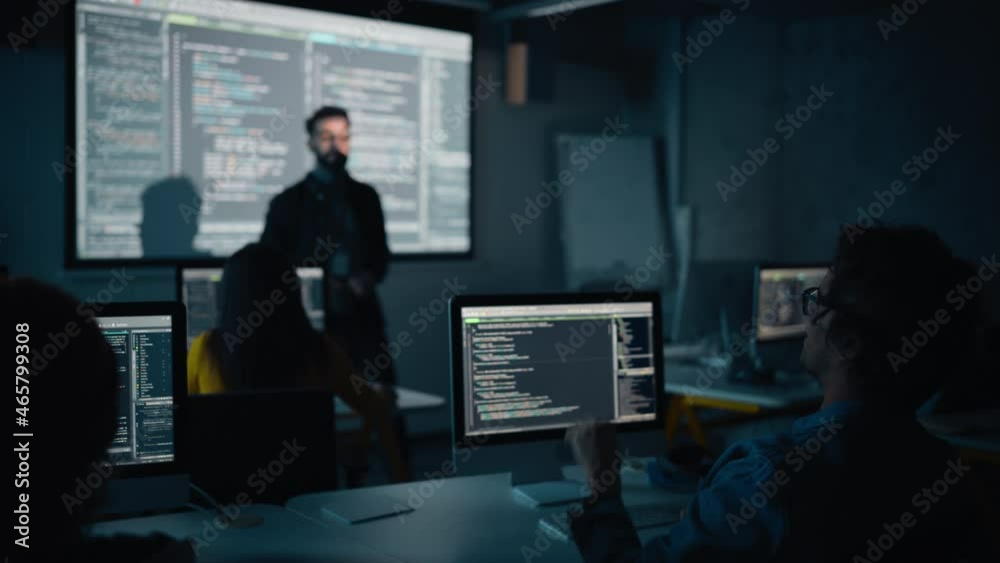 Leinwandbilder Teacher Giving Computer Science Lecture to Diverse Multiethnic Group of Female and Male Classmates in Dark College Room. Student Raises Hand and Answers Lecturer a Question About Software Engineering.