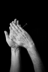 B+W image of hand demonstrating BSL sign language letter H isolated against black background