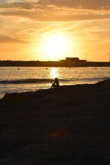 
A silhouette of a woman talking on the mobile at sunset
