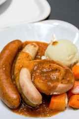 A delicious German meat sausage platter with mashed potatoes