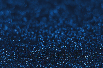 Blue sparkling glitter bokeh background, christmas abstract defocused texture. Holiday lights