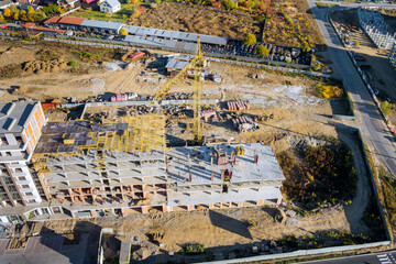 Construction of residential high rise building with a tower crane.