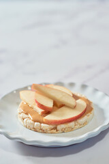 Sweet rice cakes with peanut butter and apples on top.