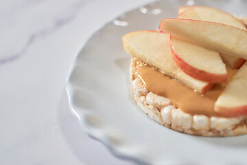 Sweet rice cakes with peanut butter and apples on top.