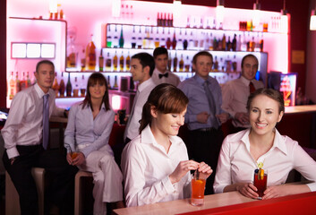 Coworkers enjoying drinks at bar after work