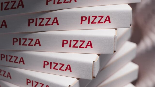 A huge pile of cardboard pizza boxes. Stack of cartons. Fast food packaging.