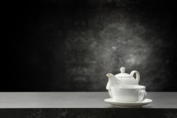 Dark tea pot on desk and free space for your decoration. 