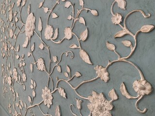 wallpaper texture on the wall with stucco flowers and leaves