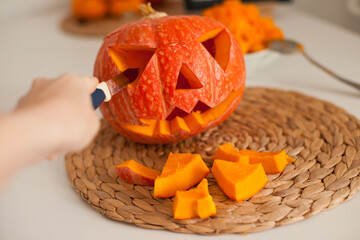 making jack-o-lantern pumpkin for halloween in the kitchen