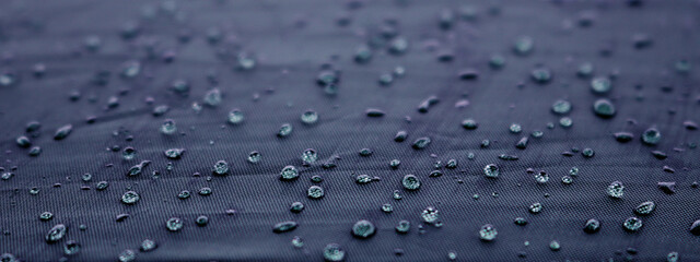 Blurred water drops on blue dark texture background texture