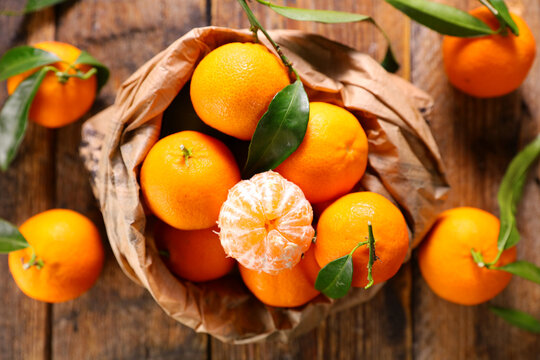 clementine- mandarin fruit and leaf background