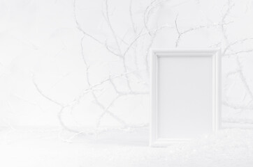 Festive christmas winter mockup with white wood blank rectangle photo frame with frosty soft light white branches and shiny snow. Bright New Year template for text, message, design, advertising.