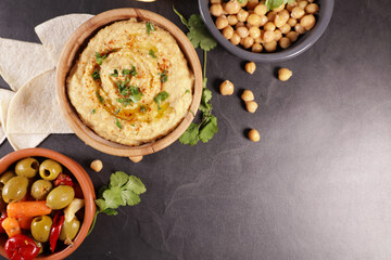 bowl of creamy hummus with olives