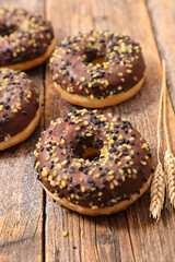 chocolate icing donut on wood background