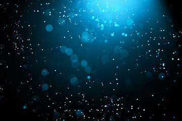 Abstract background with glowing turquoise particles.