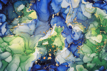 Abstract fluid art painting background in alcohol ink technique, mixture of green, blue and gold paints. Transparent overlayers of ink create lines and gradients. Burst of creativity.