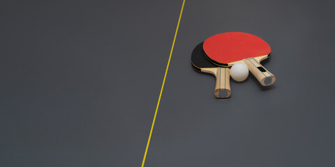 Equipment for table tennis - rackets, ball on table. banner. copy space