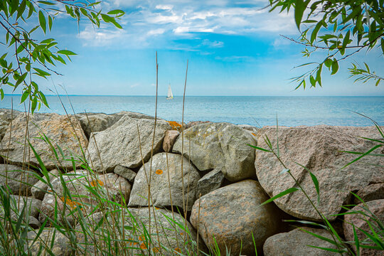A view over a stone wall and out to sea in Kivik harbor, on &Ouml;sterlen in Sk&aring;ne, Sweden