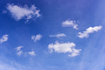 White clouds on blue sky background.