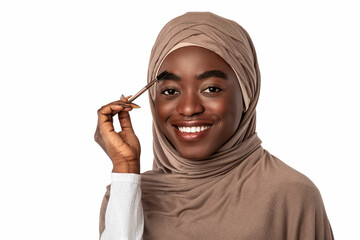 Portrait of smiling woman applying mascara on brows