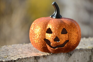 halloween jack lantern pumpkin on autumn leaves against the dark night sky at sunset. happy...