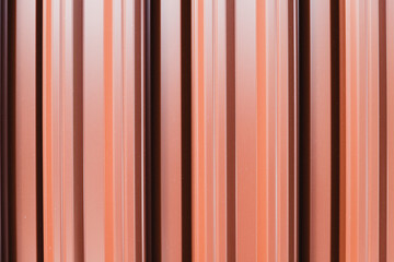 Obraz premium Shiny fence made of red metal planks, abstract photo