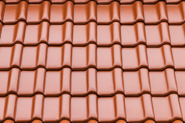 Shiny red new roof tiling, background photo
