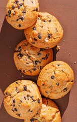 chocolate chip cookies close-up on brown background