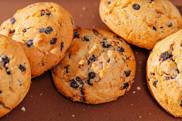 chocolate chip cookies close-up on brown background