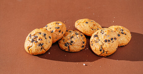 chocolate chip cookies close-up on brown background