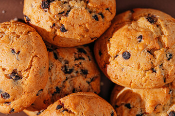 chocolate chip cookies close-up on brown background